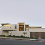 Exterior photography of modern façade/house; sunset mode frontal street view.