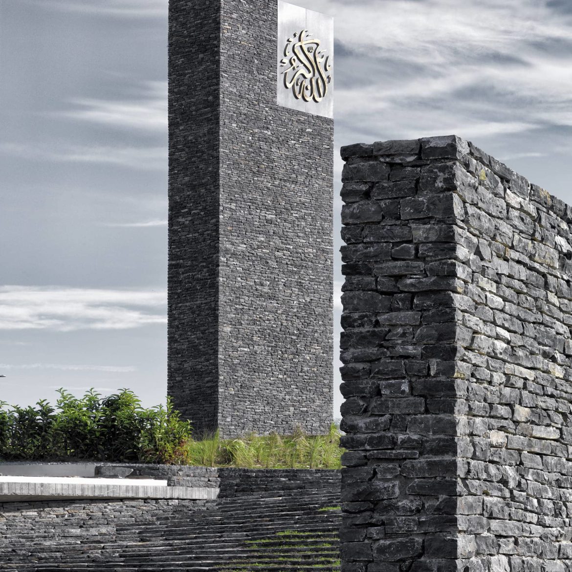 Exterior photography of stone walls and a minaret (vertical minimalist stone element) of a minimalist stone mosque; day mode angular view.