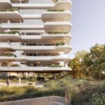 Exterior perspective rendering of a white residential building with green terraces/balconies; sunset mode frontal backyard view.